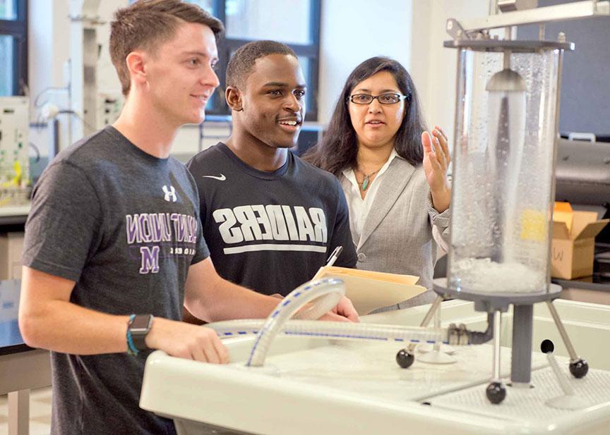 Mechanical Engineering students and professor working on an electrical water lab